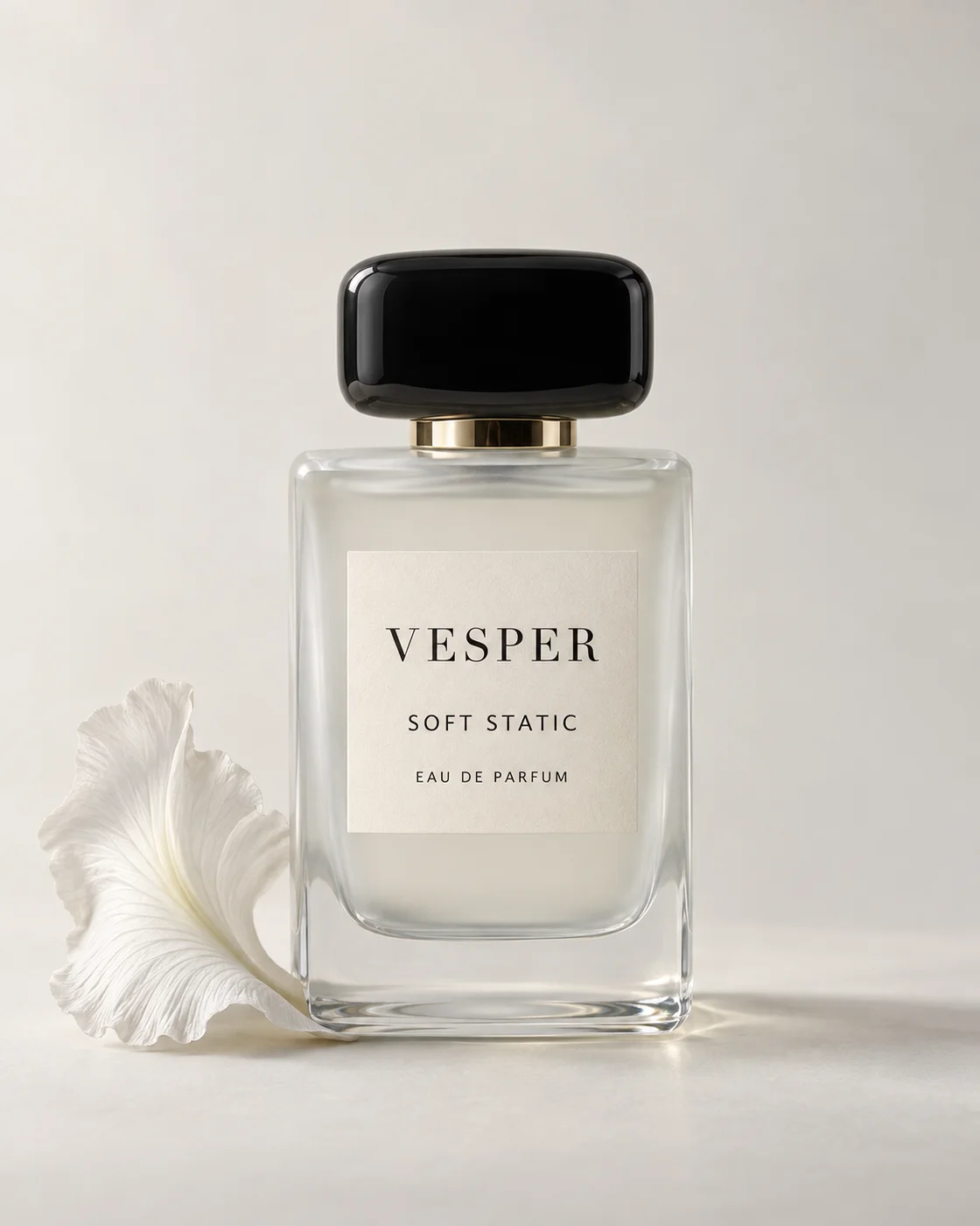 Soft Static perfume beside an iris petal in soft ivory light